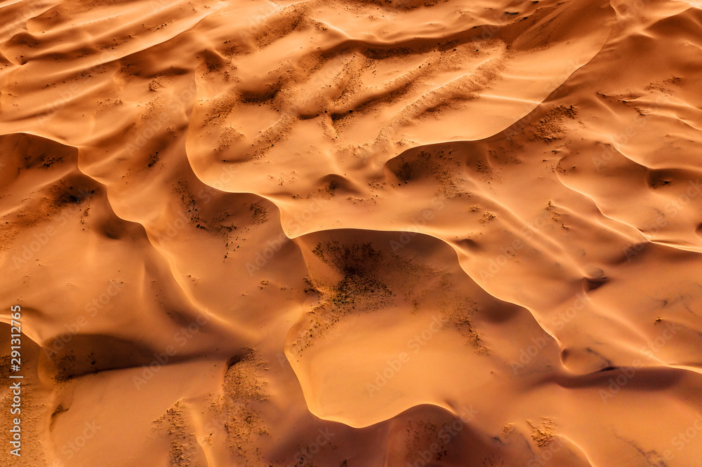 Wall mural aerial top view on sand dunes in desert