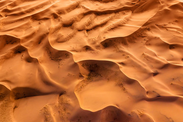 Aerial top view on sand dunes in desert - obrazy, fototapety, plakaty