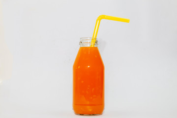 Orange juice in glass bottle Isolated on a white background.