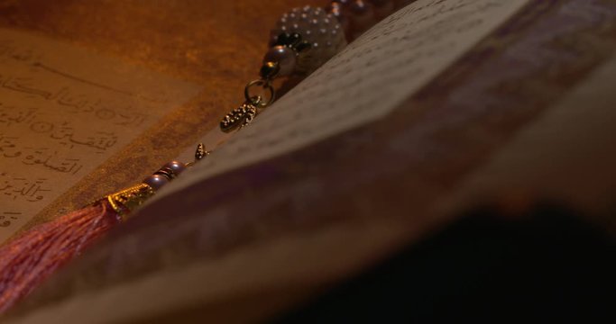 Holy Quran on Book Rest with Prayer Beads Close Up Rotation 7