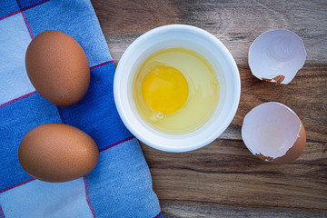 raw egg in bowl with egg shells