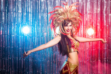 Carnival, dancer and holiday concept - Beauty brunette woman in cabaret suit and headdress with...