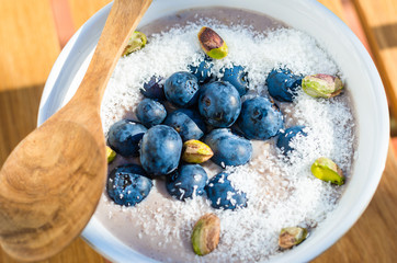 Breakfast oatmeal with soya vanilla and chocolate milk. Fruit forest mix, dried coconut, unsalted pistachios and fresh organic blueberry antioxidants. 