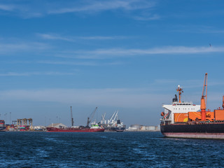 Dakar, Senegal - February 2, 2019: View of the port of Dakar in Senegal with big ships, small boats, cranes and cargos near the quay. Africa.