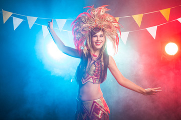 Carnival, dancer and holiday concept - Beauty brunette woman in cabaret suit and headdress with...