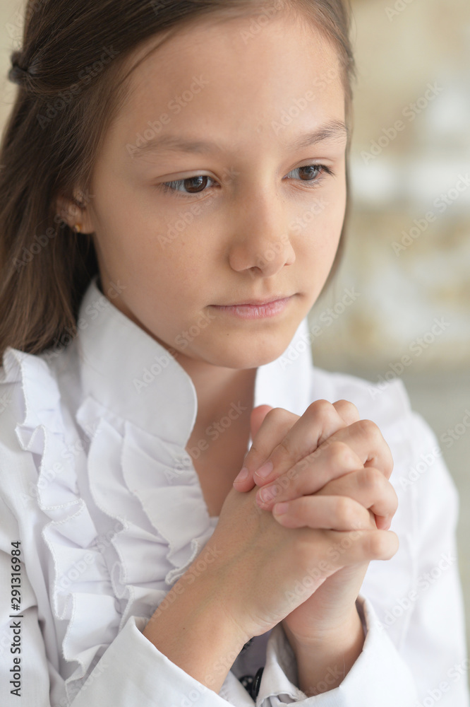 Wall mural portrait of cute girl praying at home