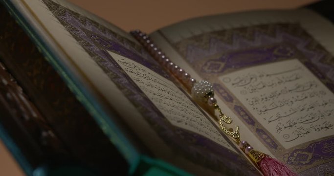 Holy Quran on Book Rest with Prayer Beads Close Up Rotation 5 Loop