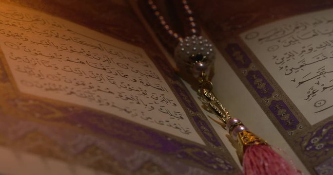 Holy Quran on Book Rest with Prayer Beads Close Up Rotation 8