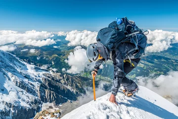 Washable wall murals Mont Blanc Extreme alpinist in high altitude on Aiguille de Bionnassay mountain summit, Mont Blanc massif, Chamonix, Alps, France, Europe