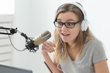 Radio host concept - Close-up of portrait of woman radio presenter with headphones