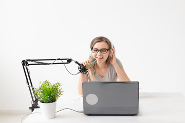 Radio host, streamer and blogger concept - Woman working as radio host at radio station sitting in...