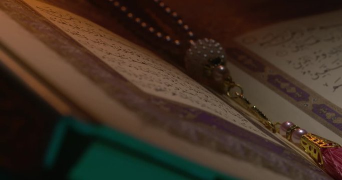 Holy Quran on Book Rest with Prayer Beads Close Up Rotation 6