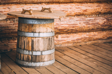 wooden barrels next to a wooden log house