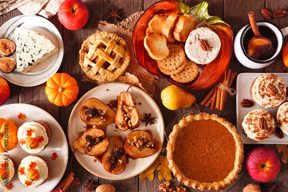 Poster autumn food concept. selection of pies, appetizers and desserts. top view table scene over a rustic 