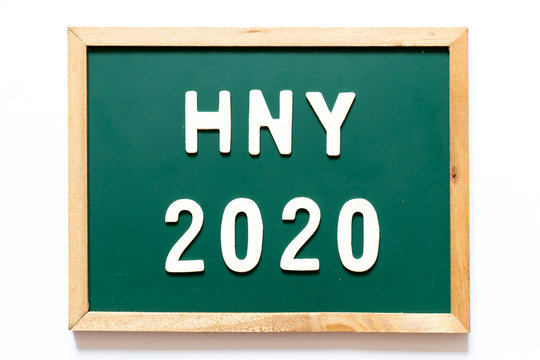 Green blackboard and wood frame with word HNY (Happy New Year) 2020 on white background