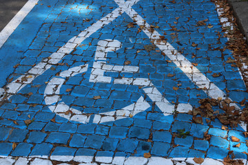 White disabled parking sign painted on blue background stock photo.