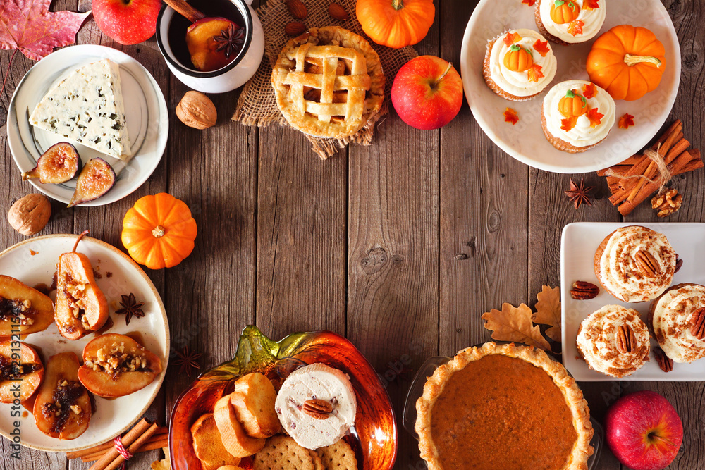 Poster autumn food frame. table scene with a selection of pies, appetizers and desserts. top view over a ru