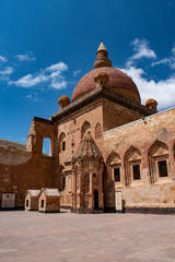 Fototapeta na wymiar Dogubayazıt, Turkey: the courtyard with the Tomb and main dome of Ishak Pasha Palace, semi-ruined palace of Ottoman period (1685-1784), one of the most magnificent historical buildings of the country