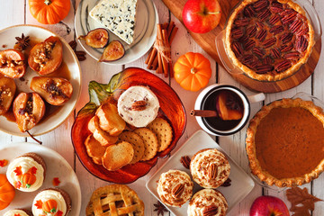 Autumn food concept. Selection of pies, appetizers and desserts. Top view table scene over a white wood background.