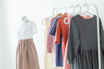 clothes, designer and Small-Sized Enterprises concept - a lot of clothes is on a hanger