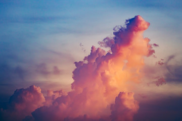 Colorful cloudy burst in sunset sky. Amazing scenery the splash of orange, blue tints on the cloudy sky. Natural phenomena. Ideal background for the creating of collages and illustrations.