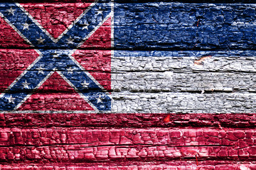The national flag of the US state Mississippi in against a black charred wooden wall on the day of independence. Political and religious disputes, fire department and firefighters.