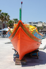 Colorful Luzzu boat in Marsaxlokk bay, Malta
