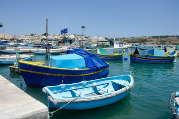 Traditional fishing boats Luzzu moored at Marsaxlokk Harbor, Malta