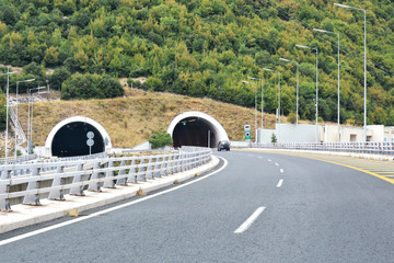 Road tunnel in mountains. Mountain road tunnel Tunnel on the highway.  Automobile trip. Pathway with tunnel. Drive through the mountain