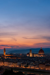 Fototapeta na wymiar Florence sunset with Lungarno (Arno river bank), the cathedral and Palazzo Vecchio (medieval city hall) illuminated