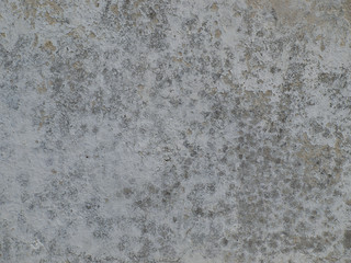  old gray plastered wall with plaster crumbled in some places