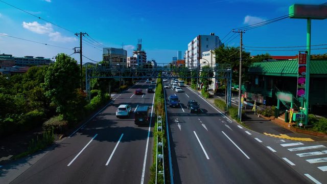 A timelapse of downtown street at Kanpachi avenue in Tokyo daytime wide shot panning