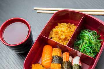 Lunch box with soy sauce on the table