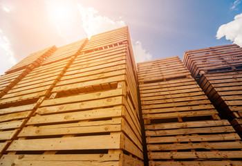 Wooden boxes stacked on each other. Outdoors. Blue sky background