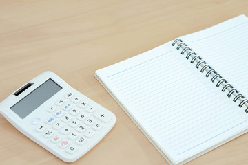 Notebook, calculator on wood