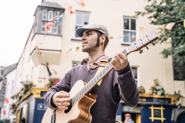 Street performer man playing the guitar