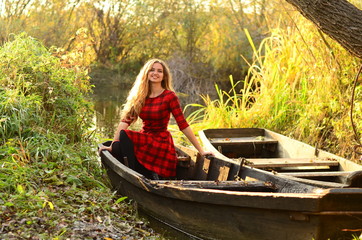 Outdoor fashion photo of young beautiful lady surrounded autumn leaves