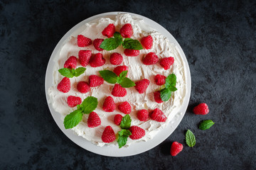 Meringue with whipped cream, raspberries.and mint