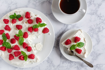 Meringue with whipped cream, raspberries.and mint