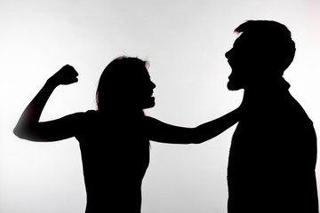 Domestic violence and abuse concept - Silhouette of a woman slapping a man