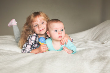 Two Beautiful sisters playing together, One 3 Years Old Toddler Girl and 6 month old Baby Girl