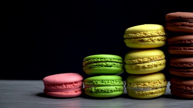 Multi-colored Macaroons On A Gray Countertop On A Dark Background. Tasty Traditional Dessert.