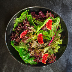 healthy salad figs, cheese, lettuce (arugula, spinach and other ingredients, snack, healthy food) menu concept. food background. copy space. Top view
