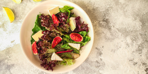 healthy salad figs, cheese, lettuce (arugula, spinach and other ingredients, snack, healthy food) menu concept. food background. copy space. Top view