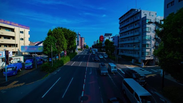 A timelapse of downtown street at Kanpachi avenue in Tokyo daytime wide shot tilt