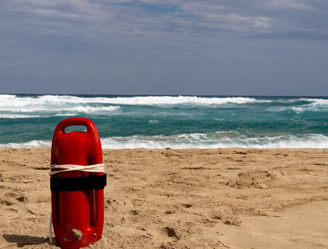 Red baywatch buoy at beach