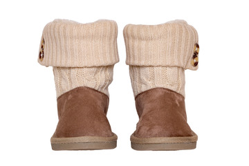 Winter boots. Close-up of a pair elegant brown suede leather winter boots with wool and lined with fur. Girls winter shoe fashion new collection. Isolated on a white background. Macro.