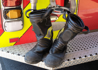 Fireman boots airing out after an emergency call on the back ramp of a local fire truck