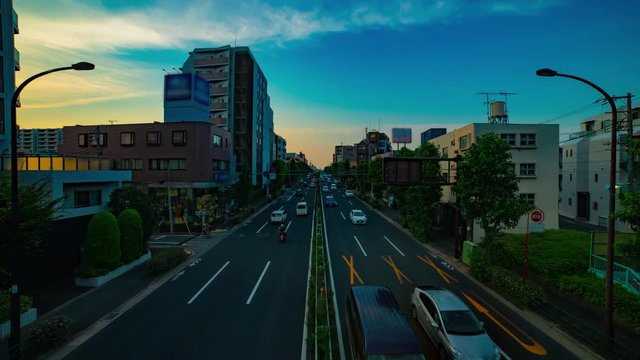 A timelapse of downtown street at Kanpachi avenue in Tokyo daytime wide shot tilt