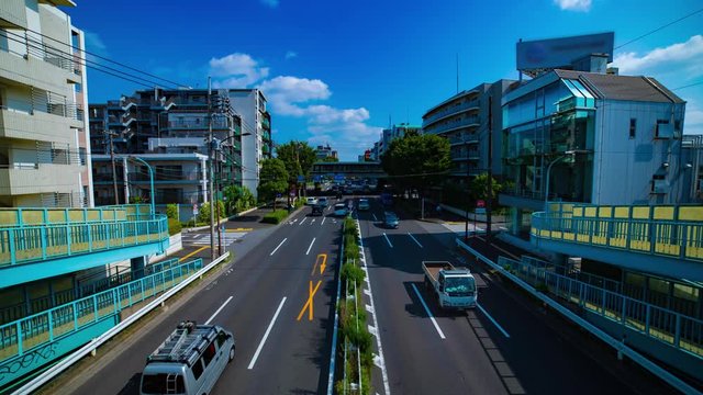 A timelapse of downtown street at Kanpachi avenue in Tokyo daytime wide shot tilt